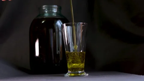 Olive oil with splashes on black background. Filmed on a high-speed camera 스톡 동영상 308839485