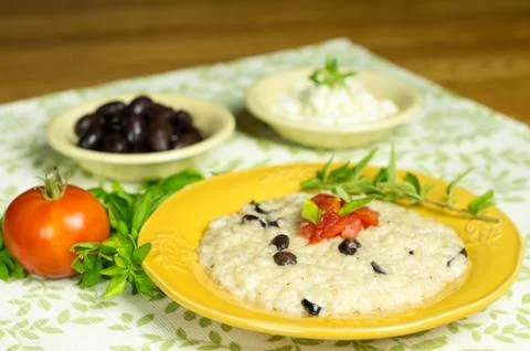 Olive risotto with tomato and herbs Stock Photos