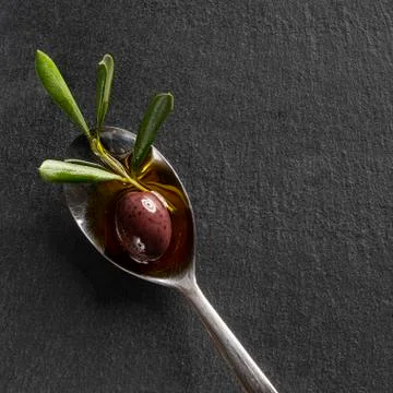 The olive in the spoon Stock Photos
