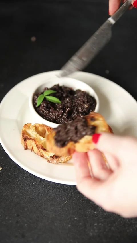 Olive tapenade appetizer black olive pâté food preparation tasty snack Stock Footage 337964246