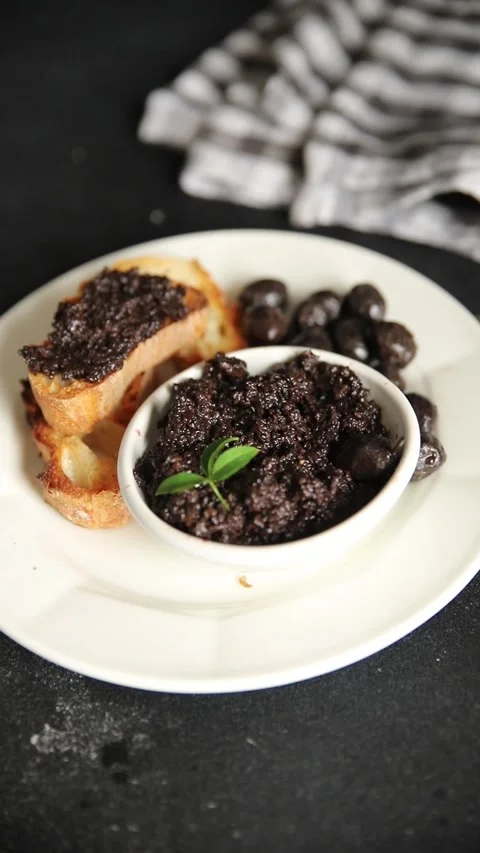 Olive tapenade appetizer black olive pâté food preparation tasty snack Stock Footage 337964254
