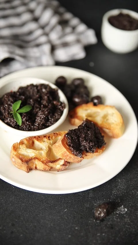 Olive tapenade appetizer black olive pâté food preparation tasty snack Stock Footage 337964258