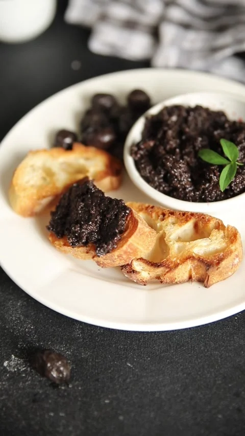 Olive tapenade appetizer black olive pâté food preparation tasty snack Stock Footage 337964260