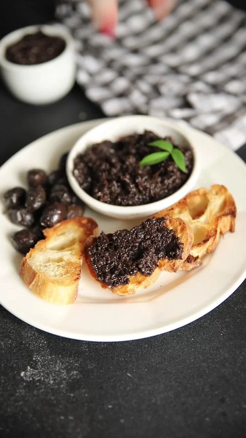 Olive tapenade appetizer black olive pâté food preparation tasty snack Stock Footage 337964261