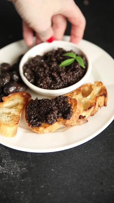 Olive tapenade appetizer black olive pâté food preparation tasty snack Stock Footage 337964265