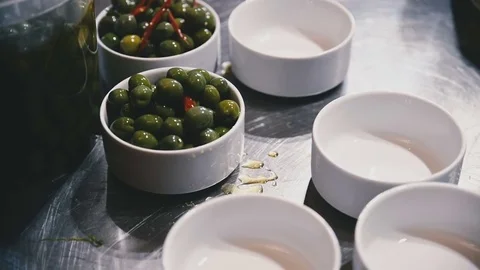 Olives are in the kitchen in white cups Stock Footage 81543762