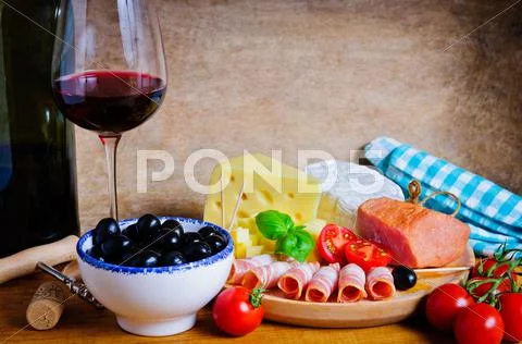 Olives, cheese, ham and wine Stock Photos