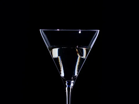 Olives fall in a glass in from martini with splashes. Stock Footage 72476812