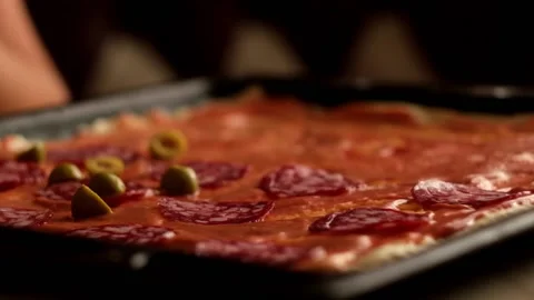 Olives falling down on homemade pizza Stock Footage 157055657