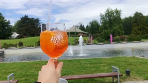 OLOMOUC, CZECH - JUN 7, 2020: Hand holding alcoholic drink Aperol Spritz Stock Footage 132129134