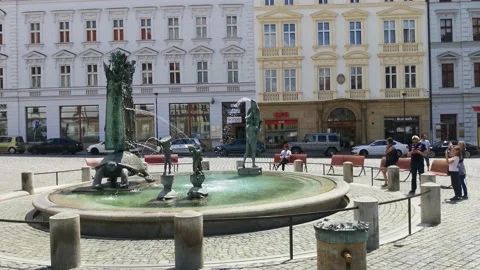 OLOMOUC, CZECH - JUN 7, 2020: People refresh themselves at the historic fountain Stock Footage 132129866