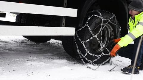 Olomouc Czech Rep Jan 25th 2022 Driver takes off snow chains of a truck tire Stock Footage 169746430