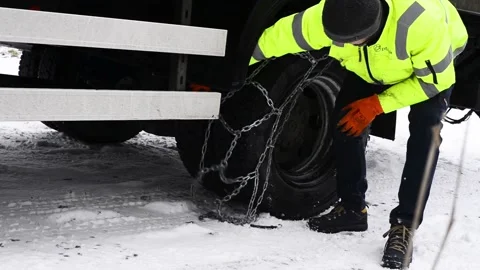 Olomouc Czech Rep Jan 25th 2022 Driver puts snow chains on a truck tire Stock Footage 170018258
