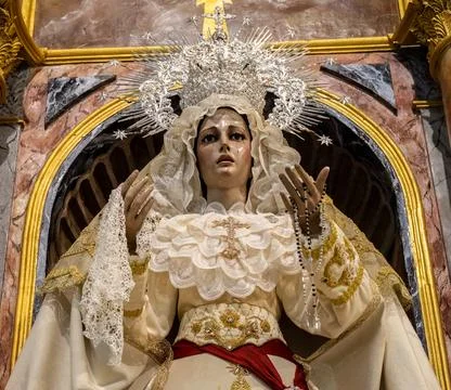 Olvera, Spain - 7 May 23: Ornate religious statue of a woman in white and gol Stock Photos