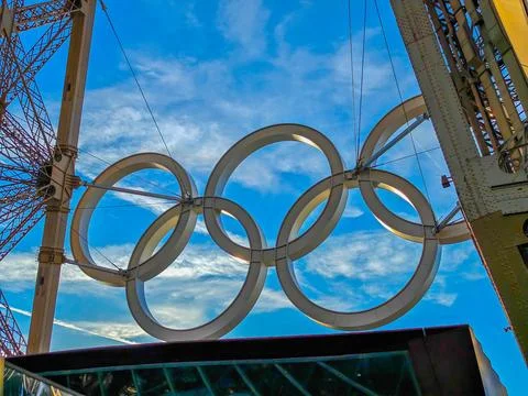 Olympic rings mounted on Eiffel tower for Paris 2024 Stock Photos