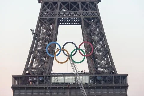 Olympic rings unveiled on the Eiffel Tower 50 days before Paris games, France -  写真素材