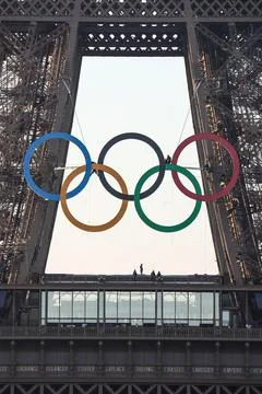 Olympic rings unveiled on the Eiffel Tower 50 days before Paris games, France -  写真素材