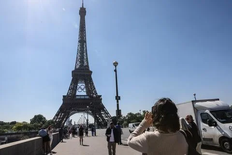 Olympic rings unveiled on the Eiffel Tower 50 days before Paris games, France -  写真素材