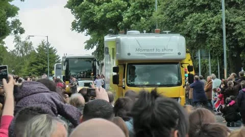 Olympic Torch Relay convoy with large crowds on hill Stock Footage 14740804