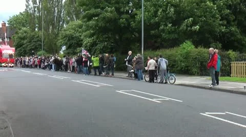 Olympic torch relay convoy makes its way through crowds towards London Stock Footage 14744923