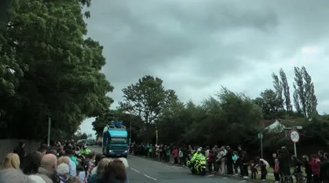 Olympic torch relay convoy on steep hill with large crowd Stock Footage 14723789