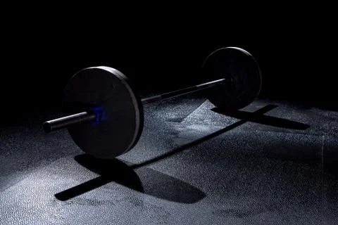 Olympic weights in gym with dramatic lighting Stock Photos