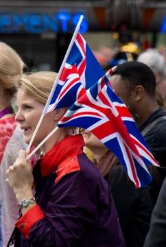 An olympics games maker holding two Union flags during the 2012 London Olympics Stock Photos
