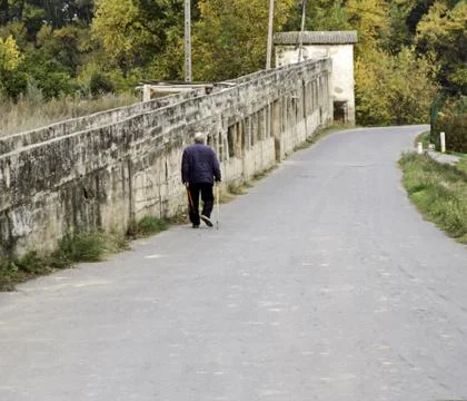 OLYMPUS DIGITAL CAMERA Elderly man walking on the street, activity and retire Stock Photos