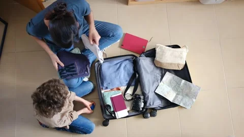 Oman preparing suitcase with 2 sons trip Vídeos de archivo 270484650