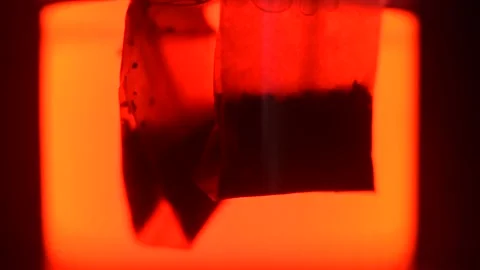 Oman puts them in the tea and raises them again. Stock Footage 136374035