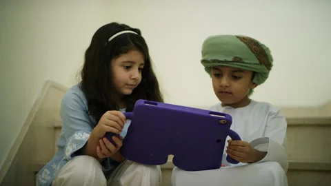 Omani kids playing with the tablet. Stock Footage 152745313