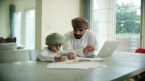 Omani man and boy studying. Stock Footage 151356945