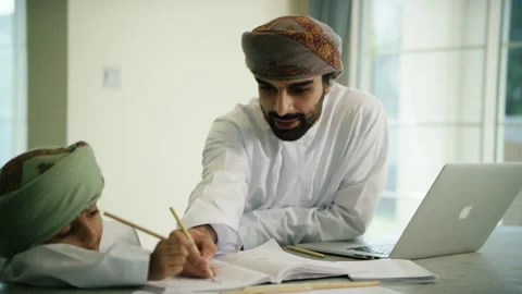 Omani man and boy studying. Stock Footage 151358345