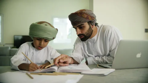 Omani man and boy studying. Stock Footage 151359205