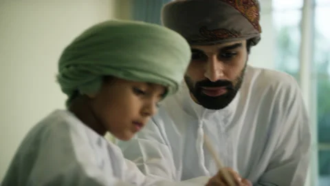Omani man and boy studying. Stock Footage 151361186