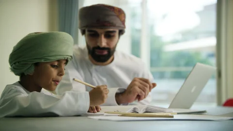 Omani man and boy studying. Stock Footage 151363383