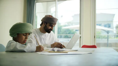 Omani man and boy studying. Stock Footage 151363742