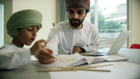 Omani man and boy studying. Stock Footage 151364765