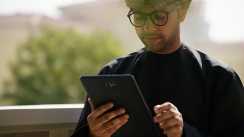 Omani man looking at his tablet. Stock Footage 152720925