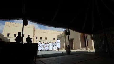 Omani men dancing a traditional dance at Nizwa Fort Vídeos de archivo 218406993