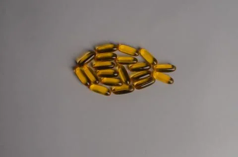 Omega 3 capsules - fish shape. Top view, copy space, high resolution product Stock Photos