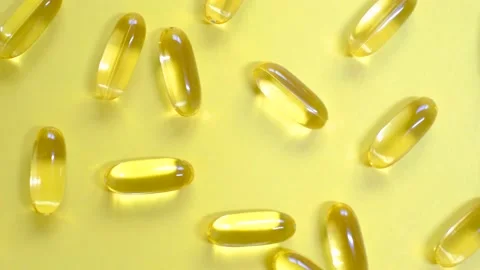 Omega 3 capsules on yellow background close-up top view. Stock Footage 228670464