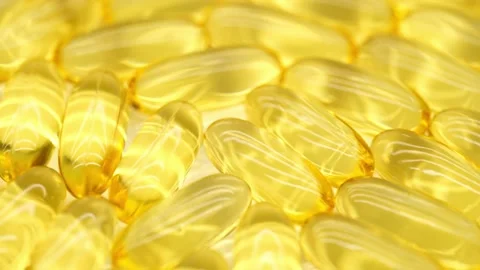 Omega 3 gold fish oil capsules, rotation background, macro. Stock Footage