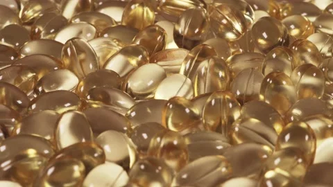 Omega 3 or D-3 pills, organic supplements vitamins yellow capsules. Dietary Video stock 145731886
