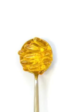 Omega 3 supplement on a spoon isolate on a white background. Selective focus. Stock Photos