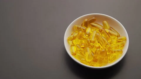 Omega capsules rotate on a table with space for text. 4K ProRes 422. Stock Footage 138156320