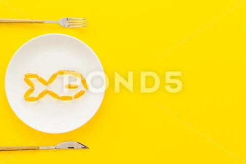 Omega fish oil supplement on plate from above Stock Photos