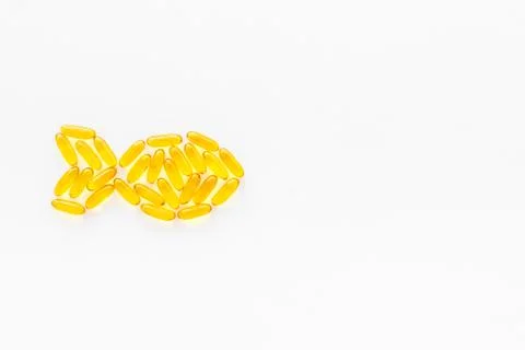Omega3 capsules cod liver oil, fish shape. Top view Stock Photos