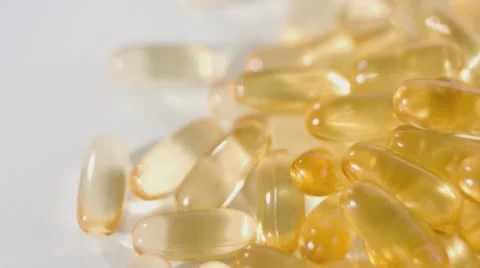 Omega3 cod-liver oil gel capsules close-up Stock Footage 59855892
