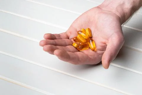Omega3 fish oil in a man's hands Stock Photos